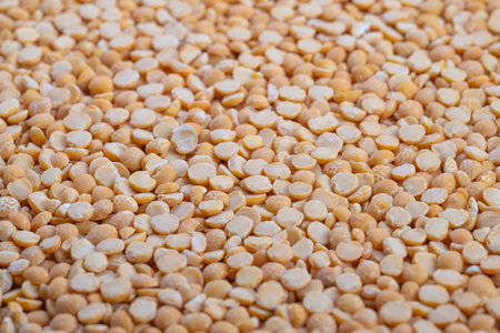 Heaped split peas ready for soup, cozy kitchen mood with implied home cook stirring pot, warm...