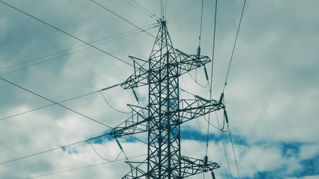 High Voltage Power Transmission Tower Standing Majestically Against a Dramatic Sky