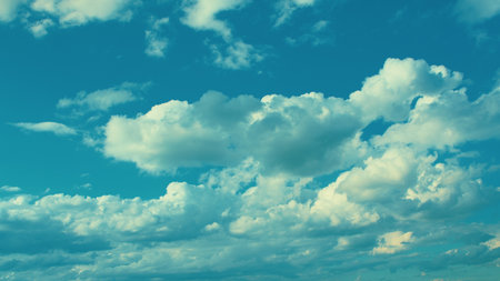 A beautiful cloudy sky is framed by a vibrant blue background, creating a stunning scene