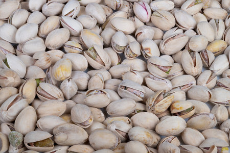 Raw pistachio kernels presented aesthetically. Creative arrangement of sundried pistachio shells...