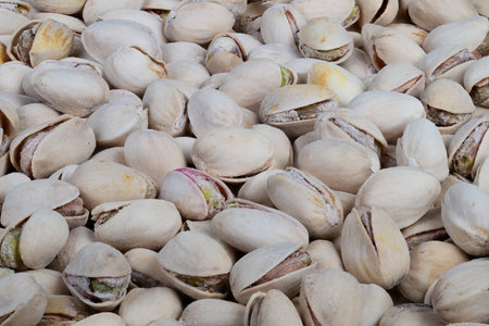 Geometric layout of pistachio shells and kernels. Background featuring natural textured pistachio...