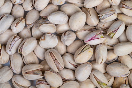 Closeup of handcrafted pistachios showcasing variety and premium appeal. Detailed image of artisan pistachios highlighting unique shells and kernels for luxury presentationの写真素材