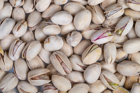 Display of raw pistachios highlighting farmfresh and eco friendly qualities. Collection of pale...