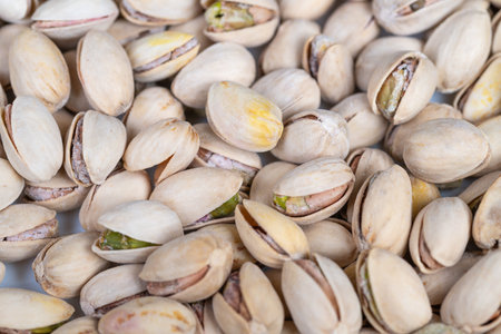 Pistachios with shells. Closeup of green shelled pistachios. Detailed view of pistachios and shells....