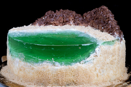 Baker preparing cake sample with visible jelly and crumb texture. Intimate kitchen scene showing...