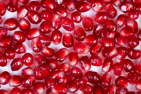 Vivid seed closeup. Detailed macro image showcasing nourishing fresh pomegranate seeds. Highly...
