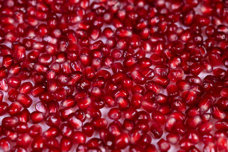 Colorful seeds emphasize health benefits. Lustrous pomegranate seeds showcase dietary richness....