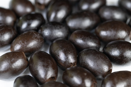 Olive texture closeup. Black olives surface detailed view. Macro photography capturing olive skin...