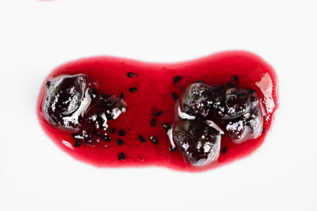 Vivid jam closeup. Intimate image showcasing textured currant jelly in studio setting. Close range...