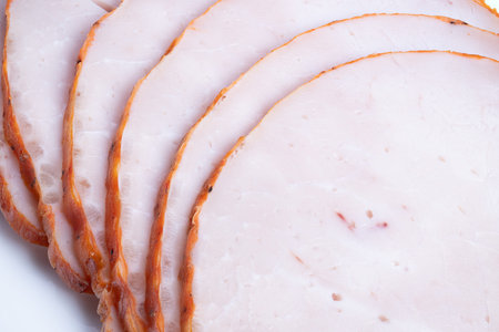 Refined arrangement of sliced roast on white background. Artistically arranged sliced roast for...