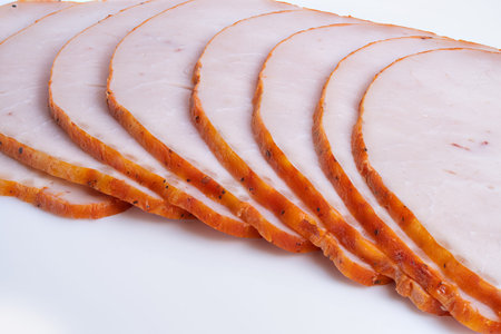 Meat presentation. Casual outdoor dining featuring rustic smoked meat slices. Natural seasoned...