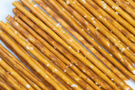 Elegant arrangement of salted pretzels showcasing gourmet bakery craftsmanship. Sophisticated display of artisanal pretzel sticks emphasizing quality and appealの写真素材
