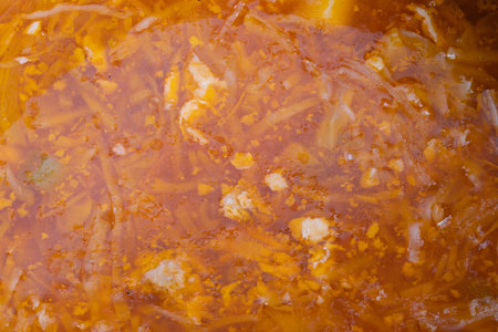 Closeup of flavorful vegetable broth, Vivid photograph showcasing textured cabbage and carrots