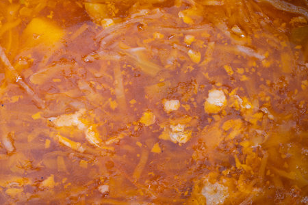 Classic soup preparation, Simmered cabbage soup with spices and root vegetables, Comforting homemade...