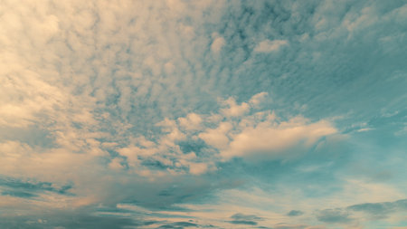 A Serene Sky Featuring Fluffy Clouds at the Beautiful Dusk Time of Day, Truly Captivatingの写真素材