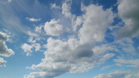Enjoying the stunningly beautiful cloud patterns that adorn a clear, vibrant blue sky