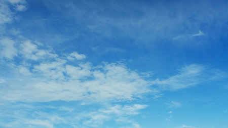 A Beautiful Blue Sky adorned with Fluffy White Clouds drifting lazily by, captivating the viewer