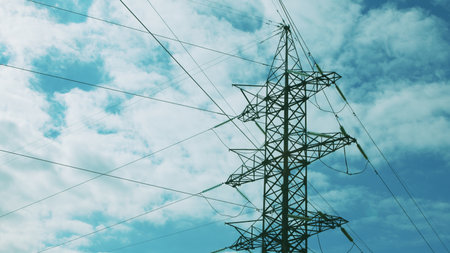 High Voltage Power Lines Silhouetted Against a Beautiful, Cloudy Sky in the Background