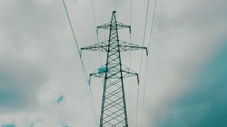 A High Voltage Power Line Stretches Across a Dramatic Cloudy Sky, Portraying Energy and Connectivity