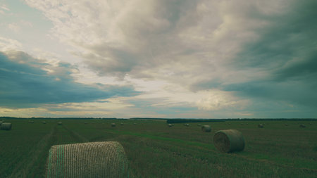 A Stunning Scenic Landscape Featuring Hay Bales Set Against a Dramatically Cloudy Sky