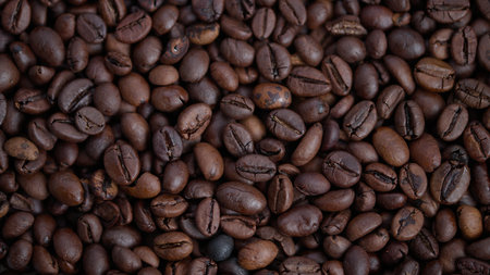 Closeup of roasted Arabica beans showing rich texture and glossy surface, Detailed view of freshly...