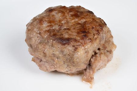 Isolated cutlet closeup on white canvas, visible juices and seared marks emphasize protein content...