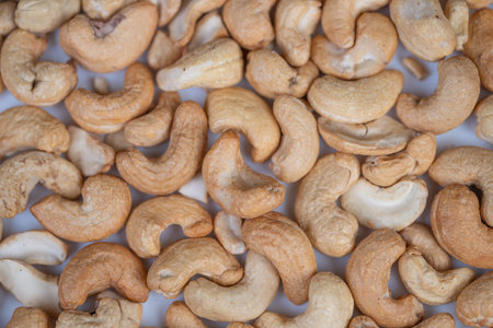 Cashew packaging display. Consistent roasted cashews for commercial packaging. Extensive flat presentation of roasted cashews ideal for food industry catalog listingsの写真素材
