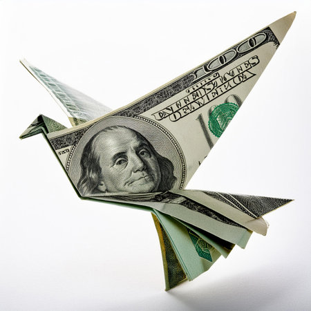 origami airplane made of dollar bills isolated on a white background.の素材
