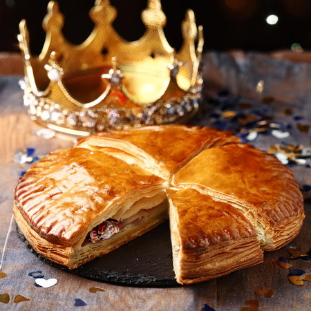 Puff pastry with raisins and a crown on a wooden tableの素材