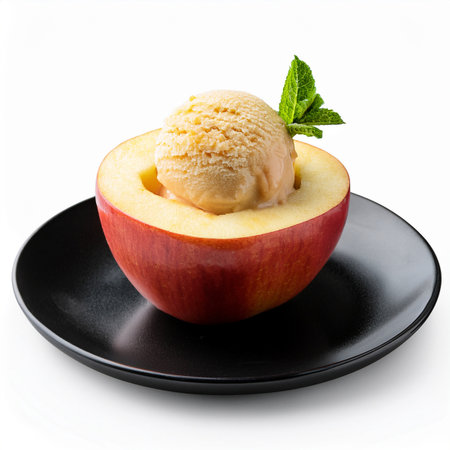 Scoop of ice cream with fresh red apple on black plateの素材
