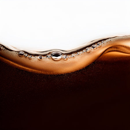 close up of a cola drink with bubbles and water dropletsの素材