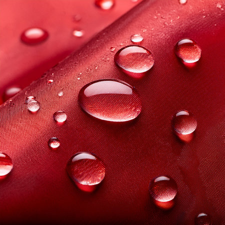 Drops of water on a red fabric as a background. macroの素材