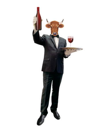 A waiter in a tuxedo holding a tray with a bottle of red wineの写真素材
