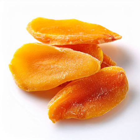 Dried mango slices isolated on white background. Healthy eating concept.の素材