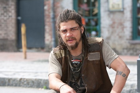 Young rebel punk with dreadlocks, tattoos,scars, and an attitude の写真素材