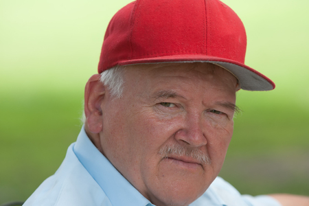 Portrait of old man with mustache outside during the dayの写真素材