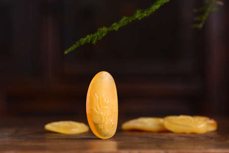 Amber beeswax floral pendants displayed on a tableの写真素材