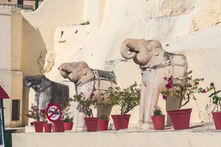 Statues of elephants on the way to Palace City Complex in Udaipur, India. Sunny day.の写真素材