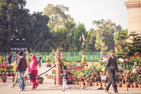 DELHI, INDIA - 05 FEB, 2014 - Indian people walking near India Gate in Delhi, India. Golden hour.のeditorial素材