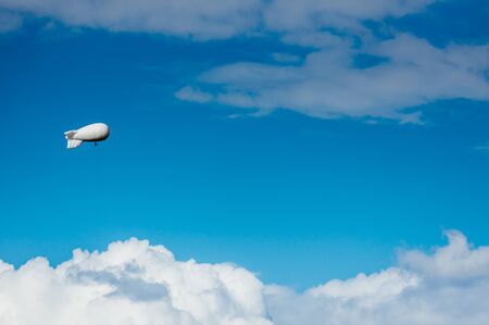 White airship with camera floating in skyの写真素材