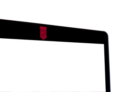 Blank laptop screen with covered webcam for security.