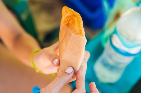 venezuelan empanada local food in hands with daylightの写真素材