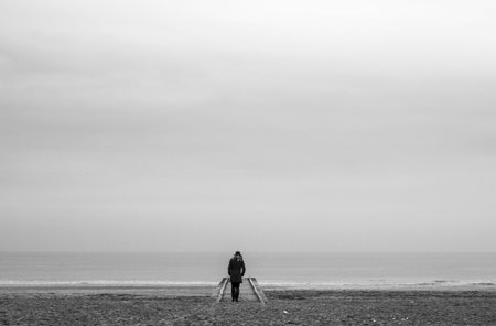 lonely woman in red dress in wooden pier at the beach with calm sea