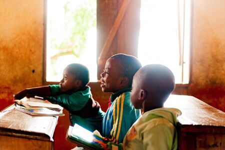 Bafoussam, Cameroon - 06 august 2018: young cameroonese boys laughing with joy during lesson in wooden village schoolのeditorial素材