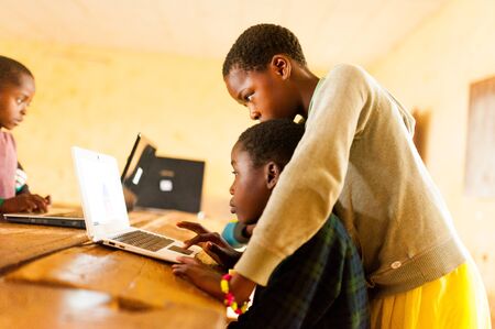 Bafoussam, Cameroon - 06 august 2018: beautiful image of african school children learning to use computer in classroom of african schoolのeditorial素材