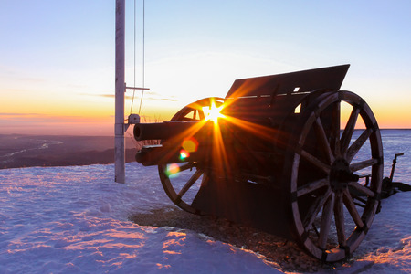 relic of first world war cannon on top of mount grappa in veneto region in italy with snow at sunriseの写真素材