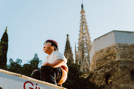 Barcelona, Spain - 06 dicember 2018: traditional christmas cagatio statue in barcelona center cathedral square during sunny winter dayのeditorial素材