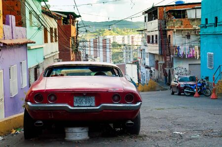 Caracas, Venezuela - 20 june 2018: old american car parked in poor city slum. The country is hit by a severe economic crisis and it's not possible to repair carsのeditorial素材