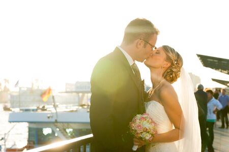 Hamburg, Germany - 23 june 2018: young german blond couple just married kissing and smiling in the street with german flag in the backgroundのeditorial素材