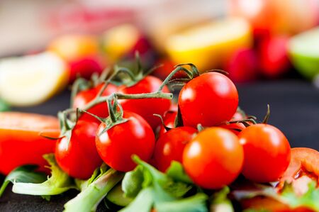 close up of red ripe fresh tomato cherries on colorful background, a very healthy and tasty foodの写真素材